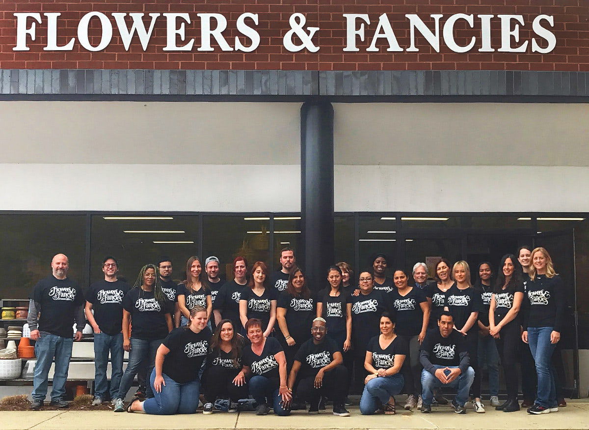 The entire Flowers & Fancies staff, gathered together outside the front door